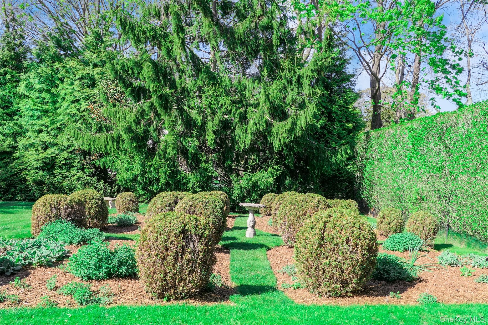 64 South Howells Point Road Bellport, NY 11713 - Photo 39 of 42 a view of a table and chairs in a garden