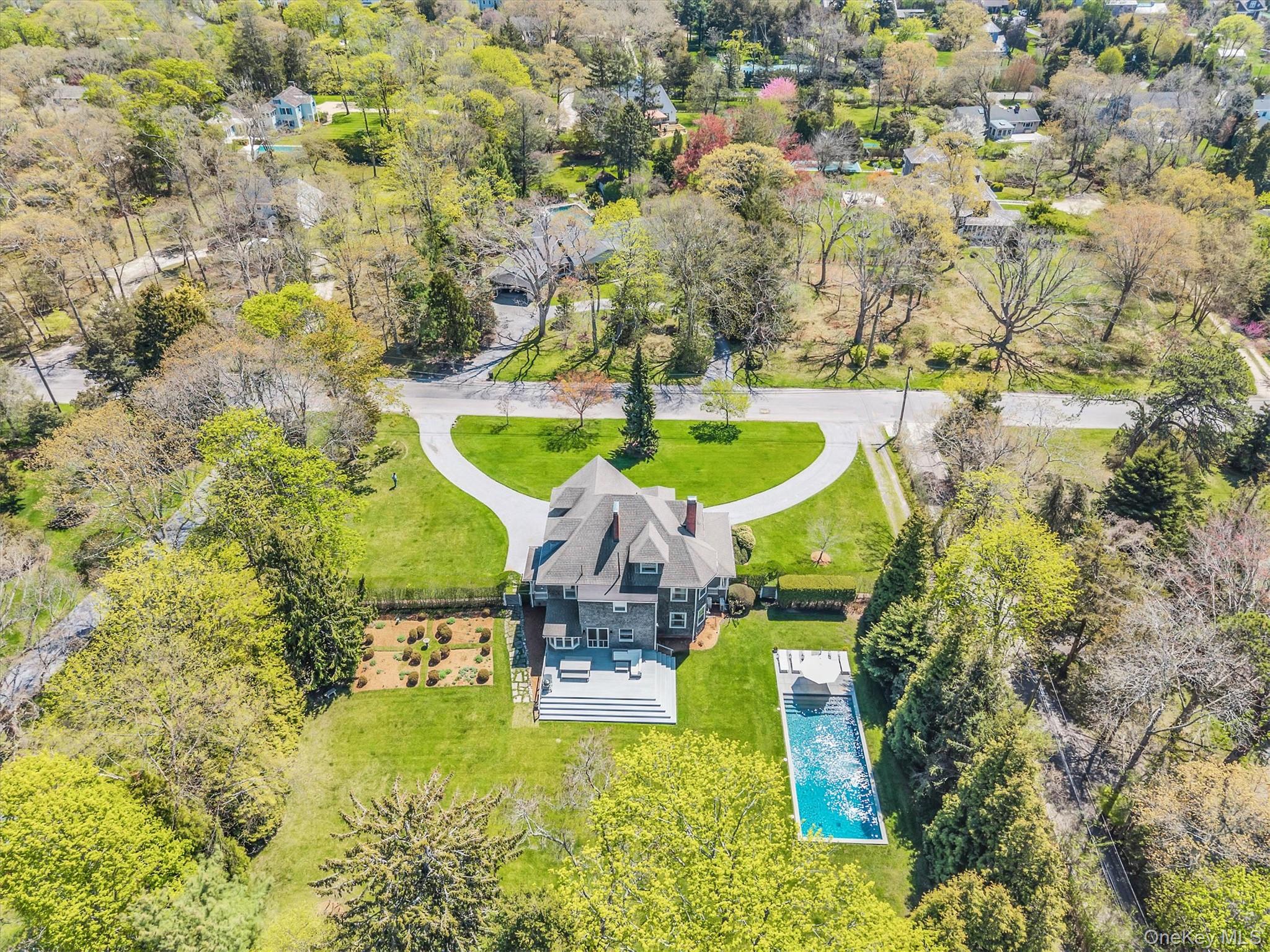 64 South Howells Point Road Bellport, NY 11713 - Photo 5 of 42 a swimming pool with outdoor seating and yard