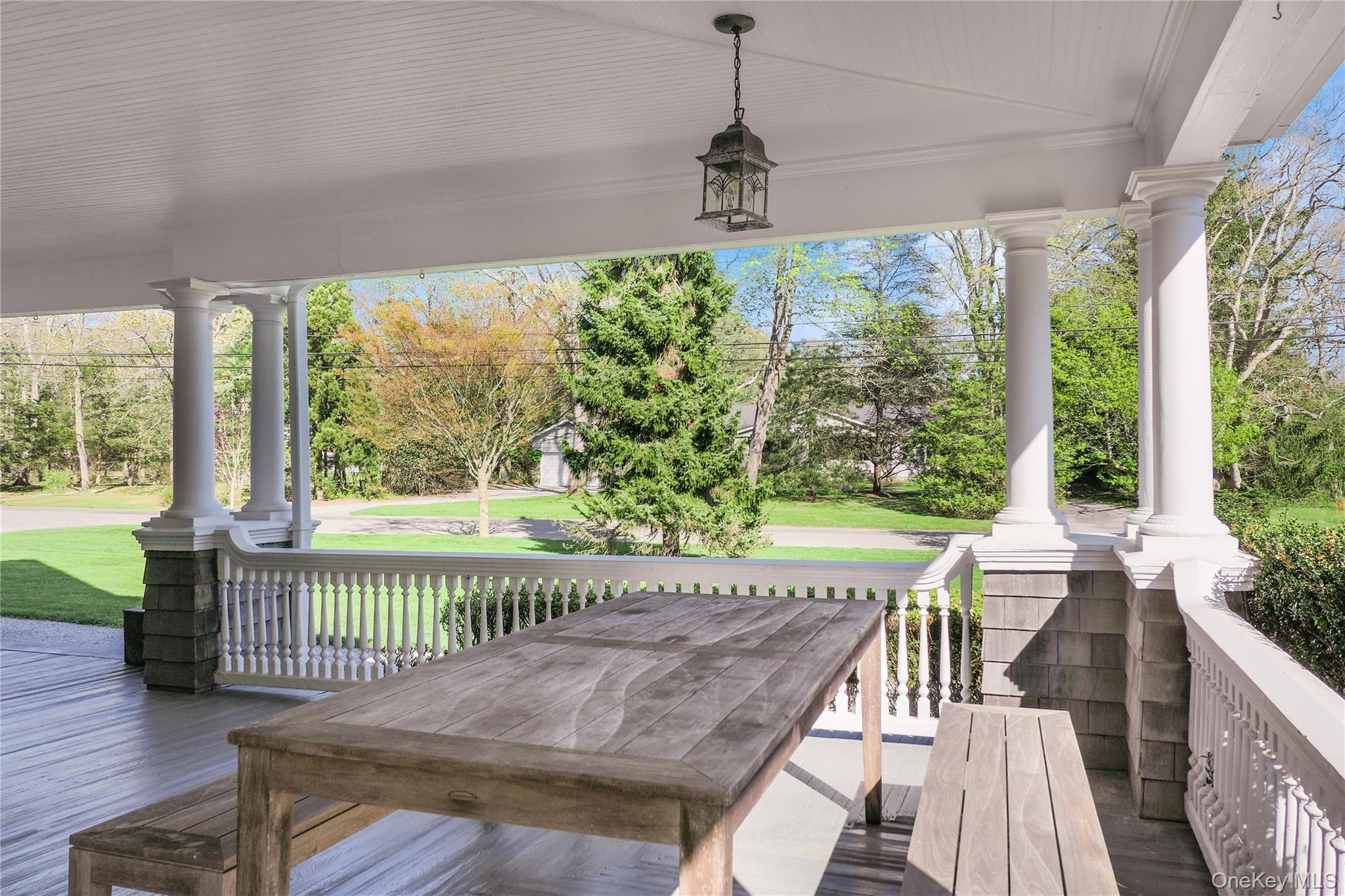 64 South Howells Point Road Bellport, NY 11713 - Photo 7 of 42 a view of a roof deck with couches and wooden floor
