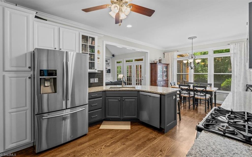 1912 Ridge Oaks Court Oak Ridge, NC 27310 - Photo 5 of 49 Bright Kitchen with Granite Countertops, SS appliances and bar seating.