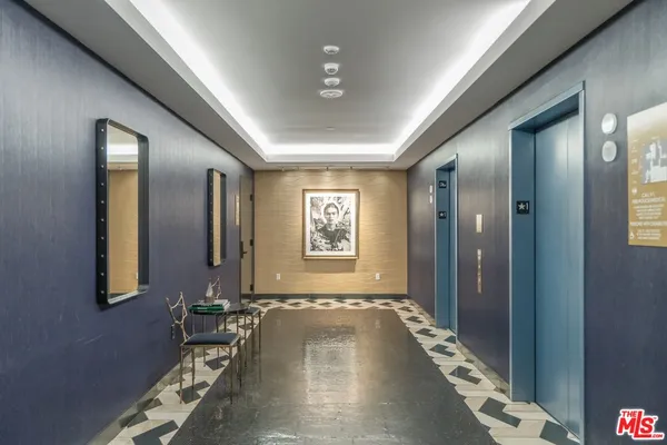 a hallway with a large mirror and furniture