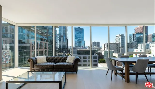 a living room with furniture and a floor to ceiling window