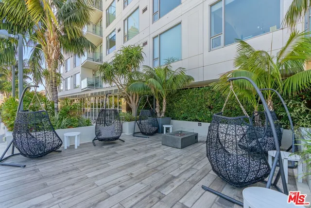 a view of a chairs and table in backyard of the house
