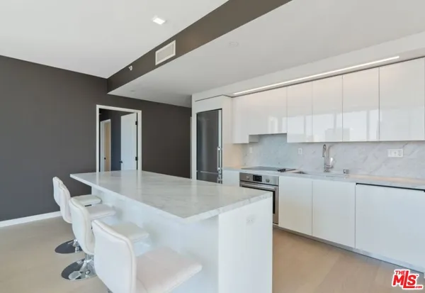 a kitchen with stainless steel appliances granite countertop a sink and cabinets