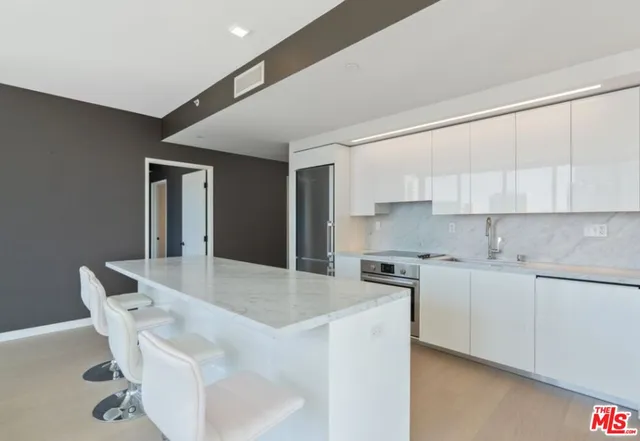 a kitchen with stainless steel appliances granite countertop a sink and cabinets