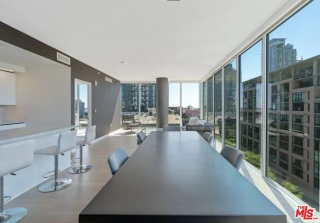 a view of a living room with furniture and floor to ceiling window