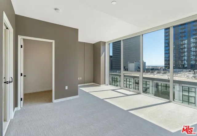 a room with pool table and large windows