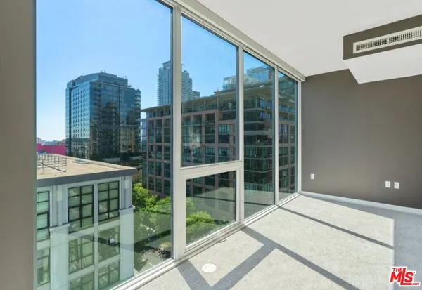 a balcony with a large window and a bench