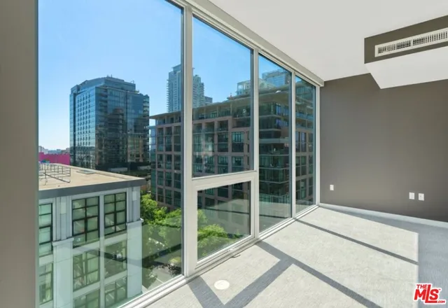 a balcony with a large window and a bench