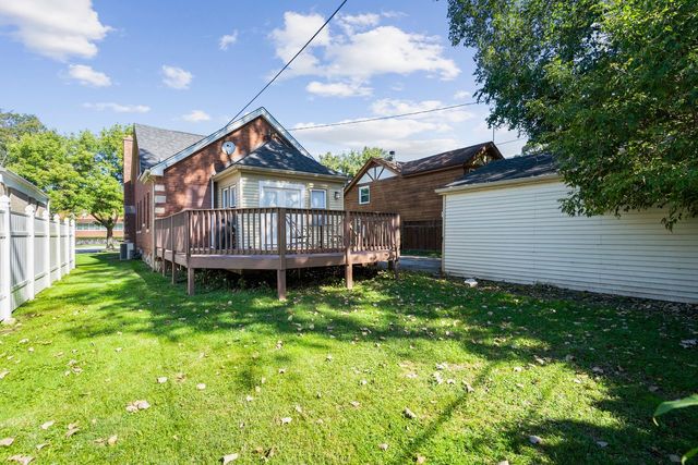 175 Ridgewood Road Riverside, IL 60546 - Photo 22 of 25 a house with tall trees in the background