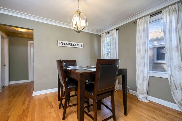 175 Ridgewood Road Riverside, IL 60546 - Photo 5 of 25 a view of a dining room with furniture wooden floor and chandelier