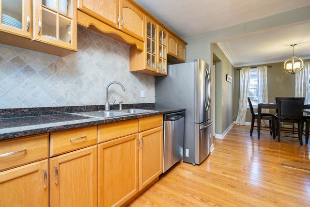 175 Ridgewood Road Riverside, IL 60546 - Photo 8 of 25 a kitchen with stainless steel appliances granite countertop a refrigerator and a stove top oven