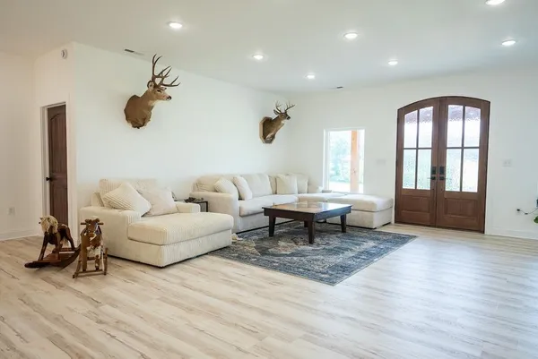 a living room with furniture and a floor to ceiling window