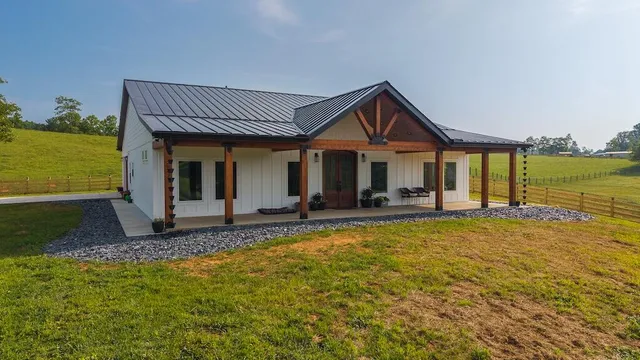 a view of a house with pool and outdoor next to a yard