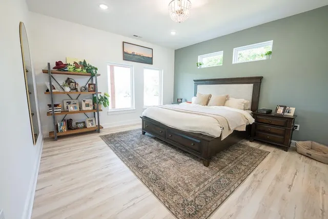 a living room filled with furniture hardwood table and a large window