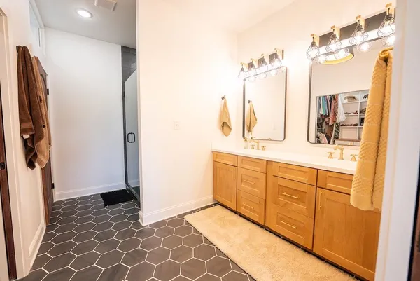 a bathroom with a sink a mirror and a shower