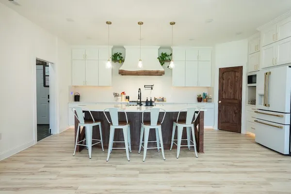 a kitchen with a stove and a refrigerator