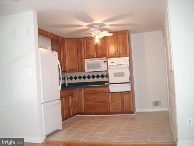 8430 Avery Road Rosedale, MD 21237 - Photo 3 of 10 a kitchen with stainless steel appliances a refrigerator and a stove