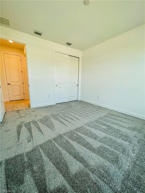 1962 Tripletail Lane Naples, FL 34114 - Photo 17 of 39 an empty room with a wooden door