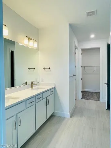 a spacious bathroom with a shower sink and mirror