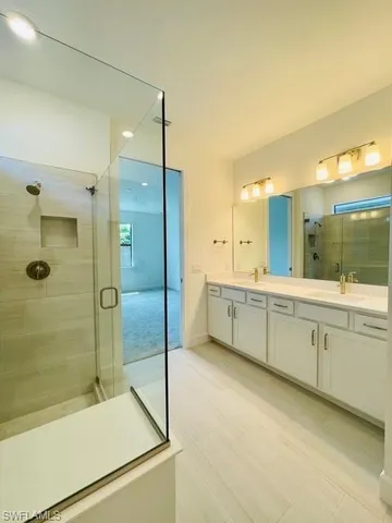 a bathroom with a granite countertop sink mirror and shower