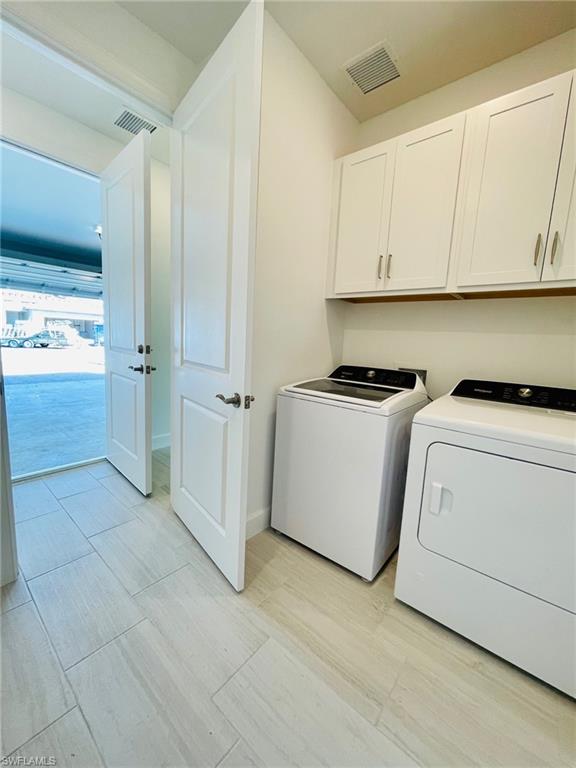 1962 Tripletail Lane Naples, FL 34114 - Photo 27 of 39 a utility room with cabinets washer and dryer