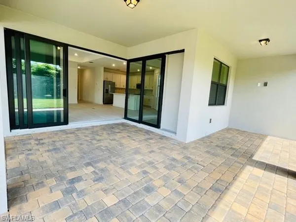a view of a hallway with wooden floor and sliding door