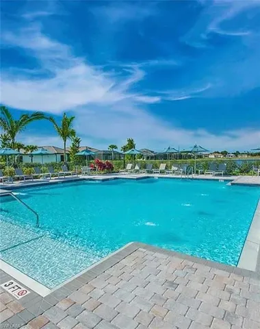 a view of a city with lawn chairs and large trees