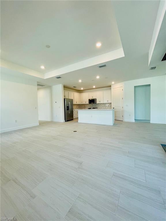 1962 Tripletail Lane Naples, FL 34114 - Photo 5 of 39 a view of empty room with kitchen