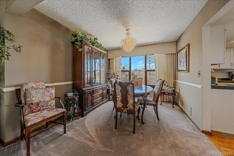 a view of a dining room with furniture and a window