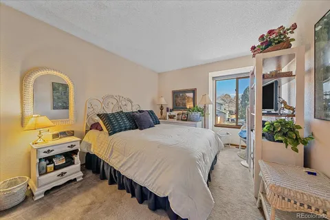 a bed room with a bed and a potted plant