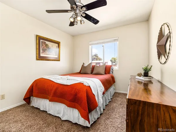 a bedroom with bed and wooden floor