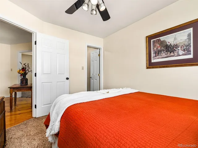 a bedroom with a bed and a painting on the wall