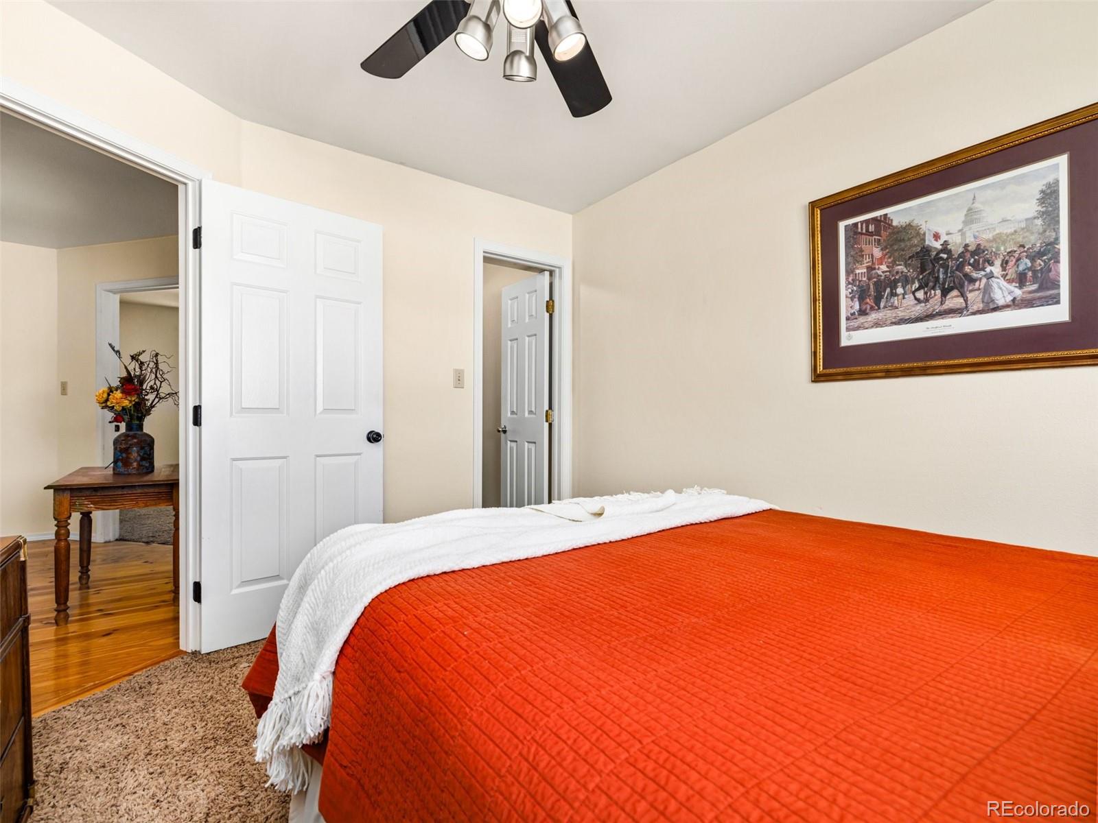 919 South Main Street Fowler, CO 81039 - Photo 12 of 36 a bedroom with a bed and a painting on the wall