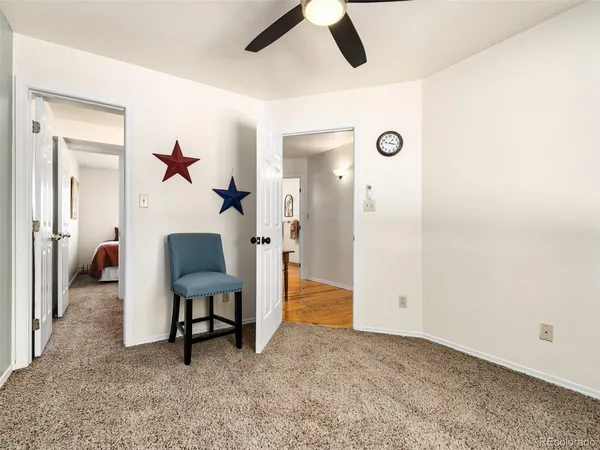 a view of a livingroom with furniture and a ceiling fan