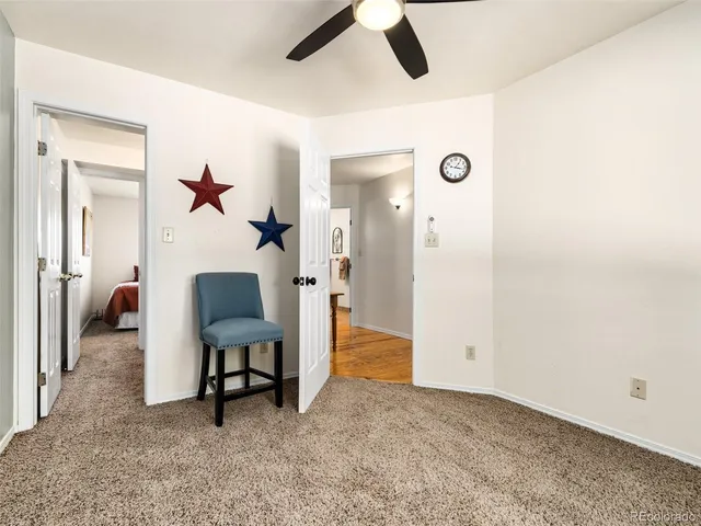 a view of a livingroom with furniture and a ceiling fan