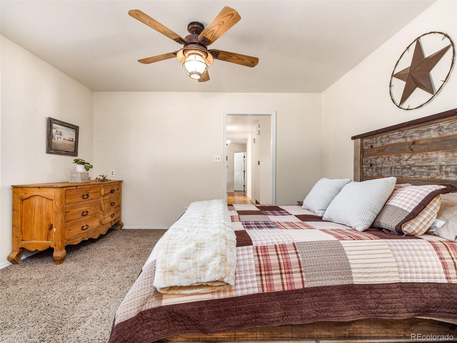 919 South Main Street Fowler, CO 81039 - Photo 20 of 36 a bedroom with a bed and a chandelier
