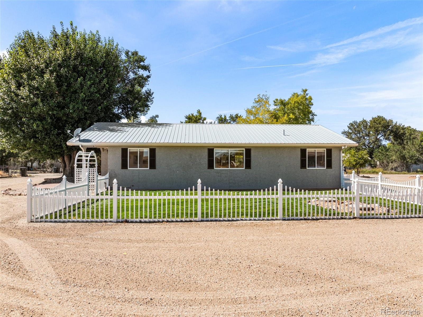 919 South Main Street Fowler, CO 81039 - Photo 32 of 36 a front view of a house with a garden and deck