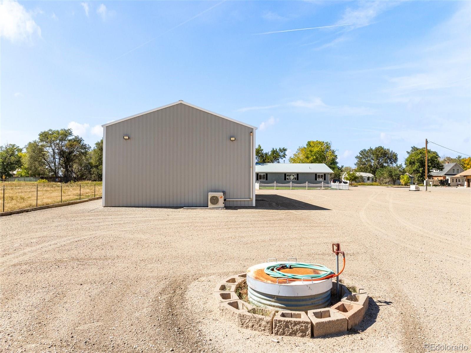 919 South Main Street Fowler, CO 81039 - Photo 34 of 36 a view of a lake with a table and chairs in front of it