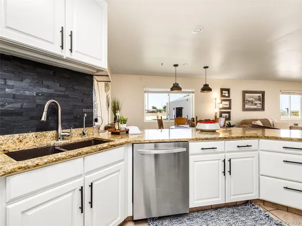 a kitchen with a sink dishwasher and cabinets