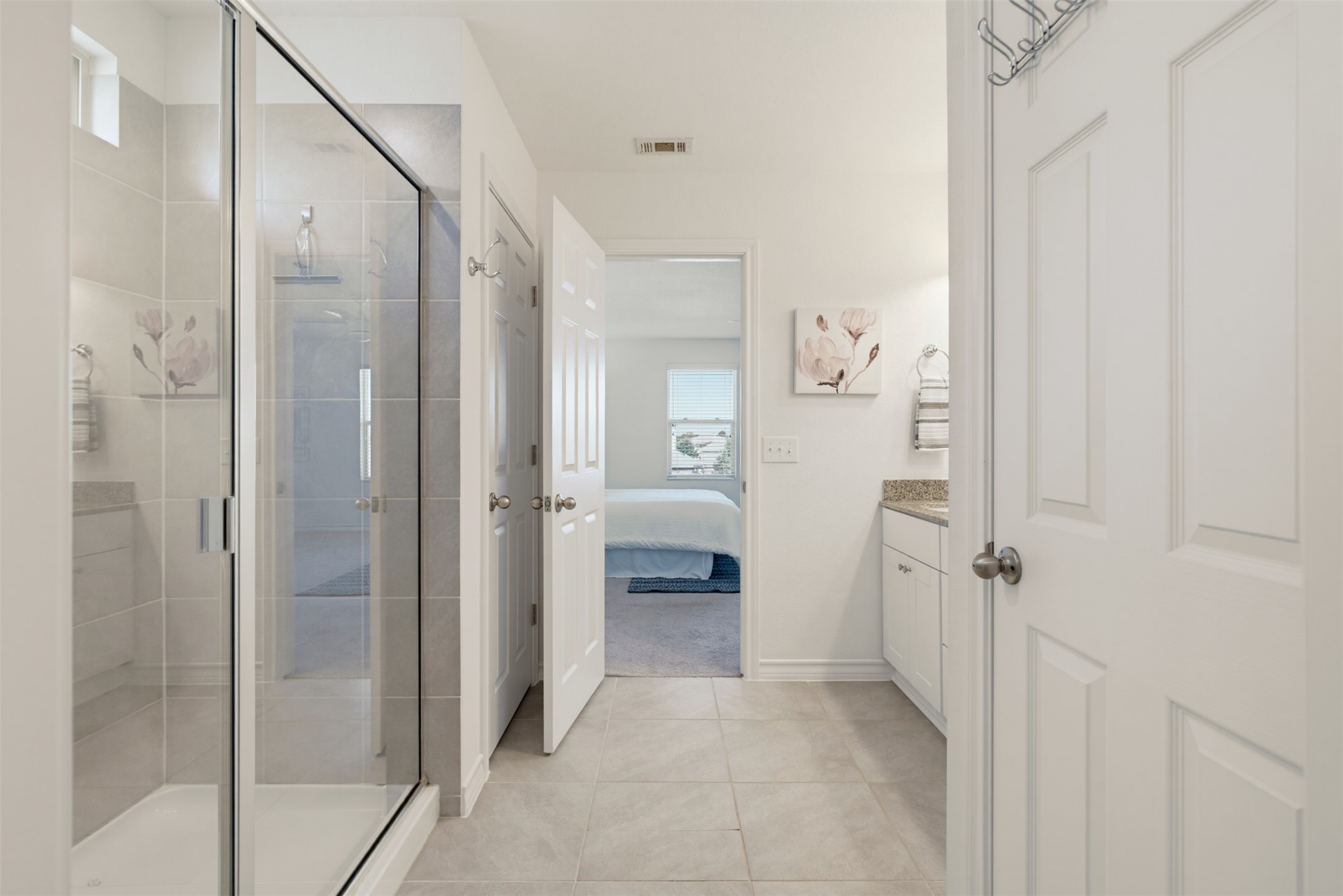 11008 Players Path Austin, TX 78747 - Photo 17 of 26 A glass-enclosed shower and tiled flooring define this bright, functional bathroom layout.