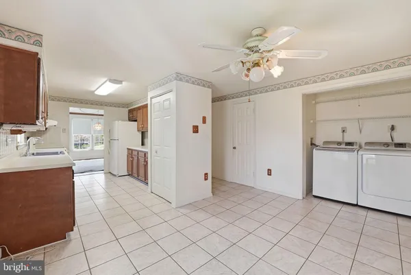a view of a kitchen with white cabinets