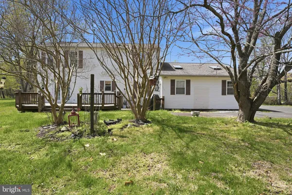 a front view of a house with a yard table and chairs