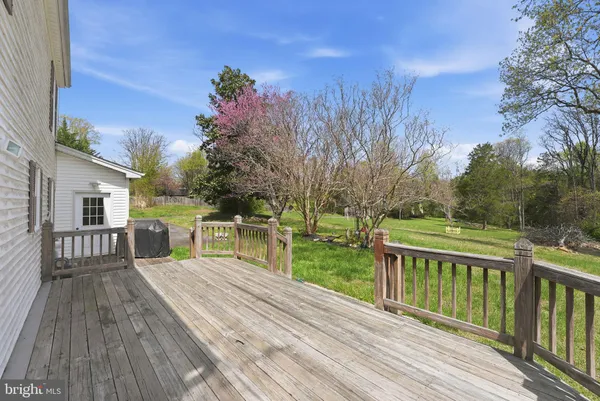 a view of balcony with wooden floor and fence
