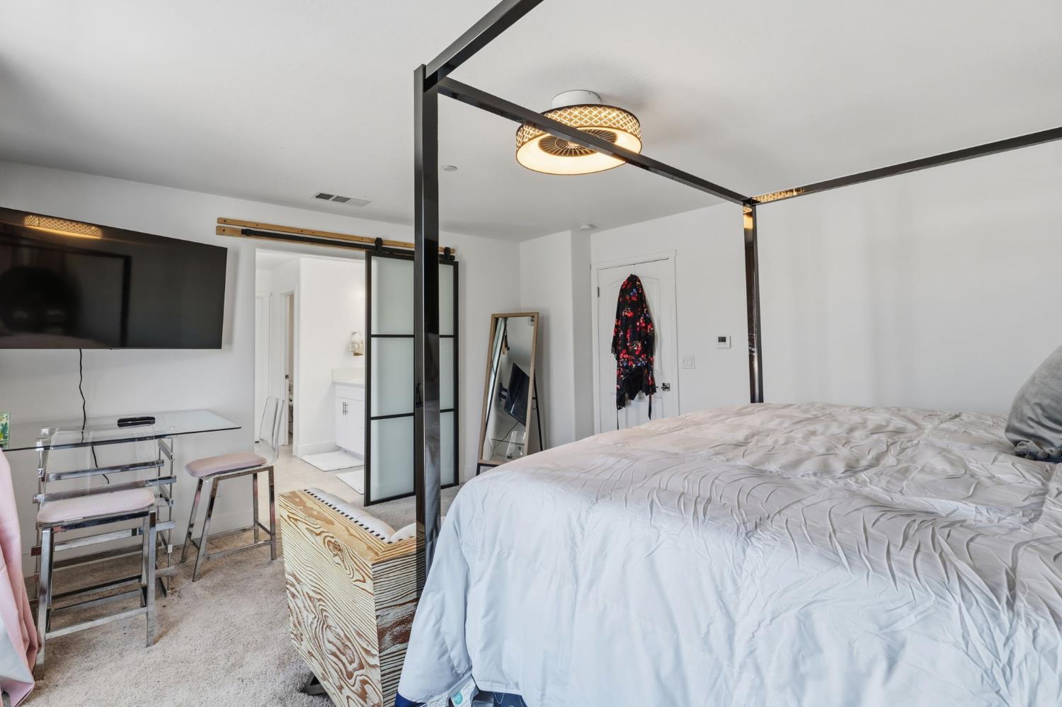 6326 West Richert Avenue Fresno, CA 93723 - Photo 25 of 45 a bedroom with a bed a flat screen tv and a walk in closet