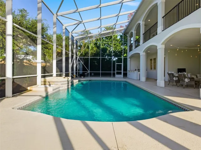 a dining area with furniture and large windows