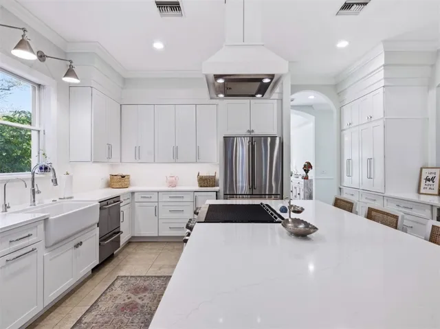 a kitchen with a sink appliances and cabinets