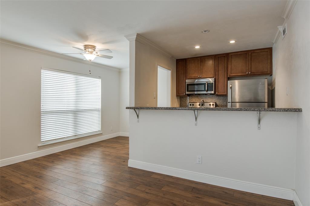 3907 Gilbert Avenue, Unit 5 Dallas, TX 75219 - Photo 7 of 11 a view of a kitchen with a sink cabinets and wooden floor