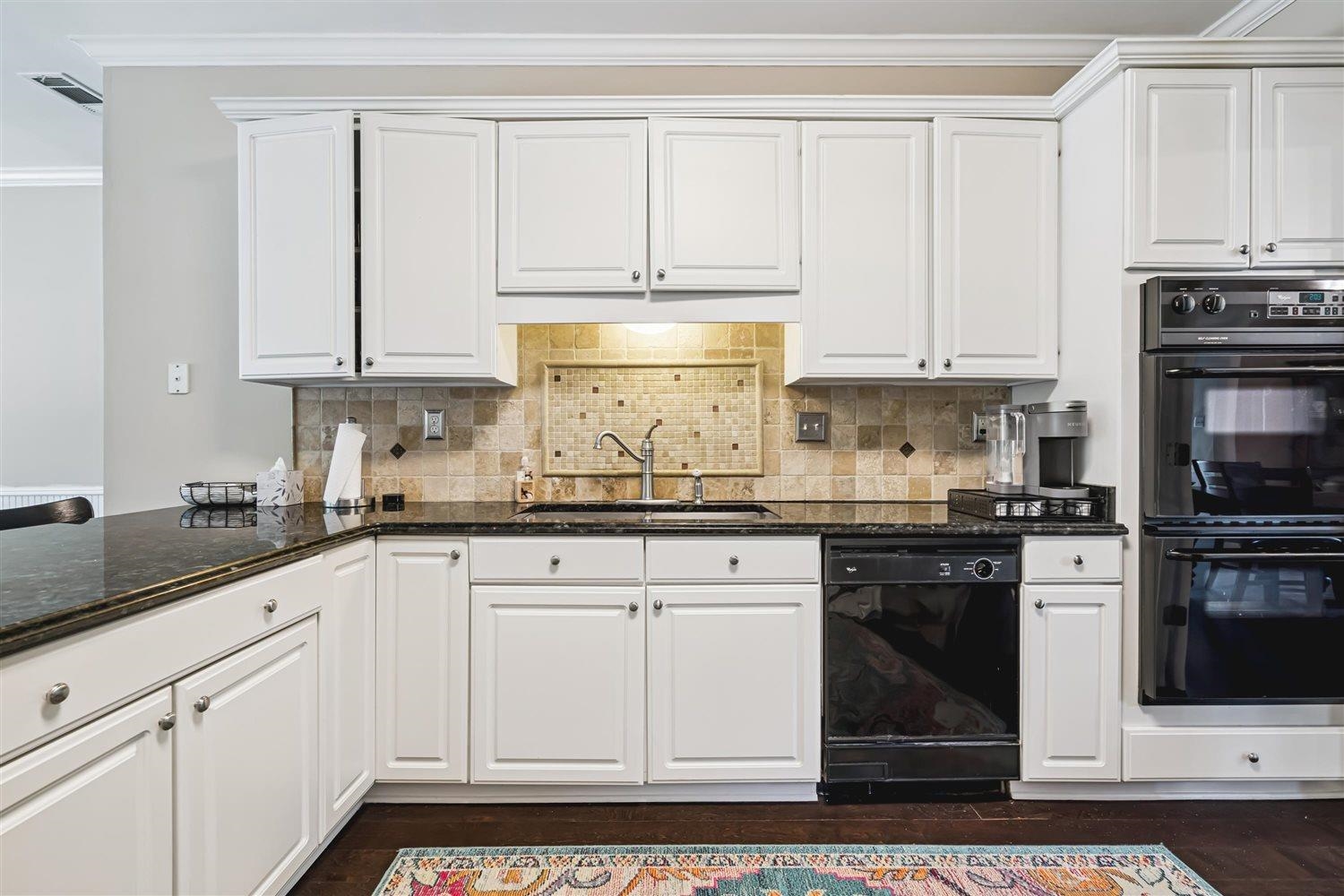 1489 John Ridge Drive Collierville, TN 38017 - Photo 17 of 39 a kitchen with granite countertop white cabinets and stainless steel appliances