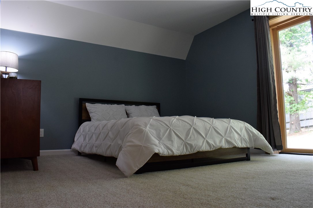 146 Trillium Ridge Boone, NC 28607 - Photo 22 of 41 a bed sitting in a bedroom next to a window